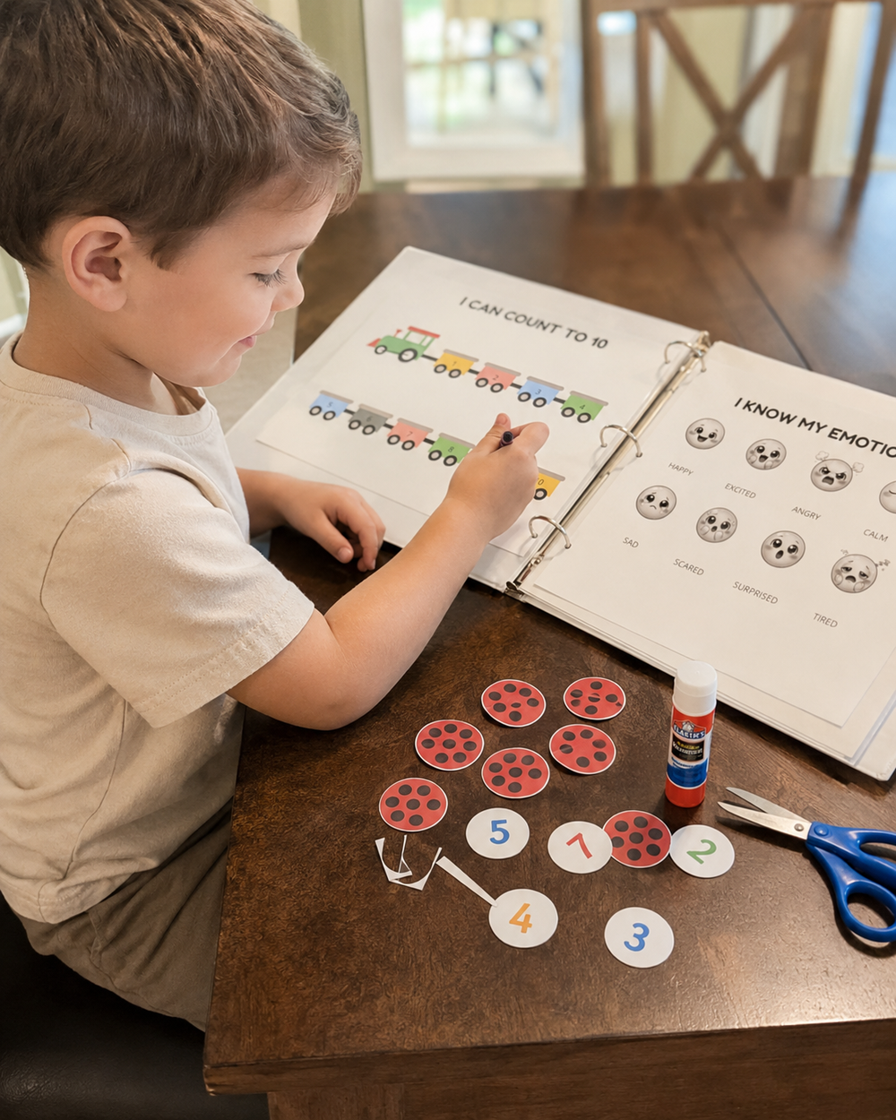 Boy counting with printable train and number activities at home
